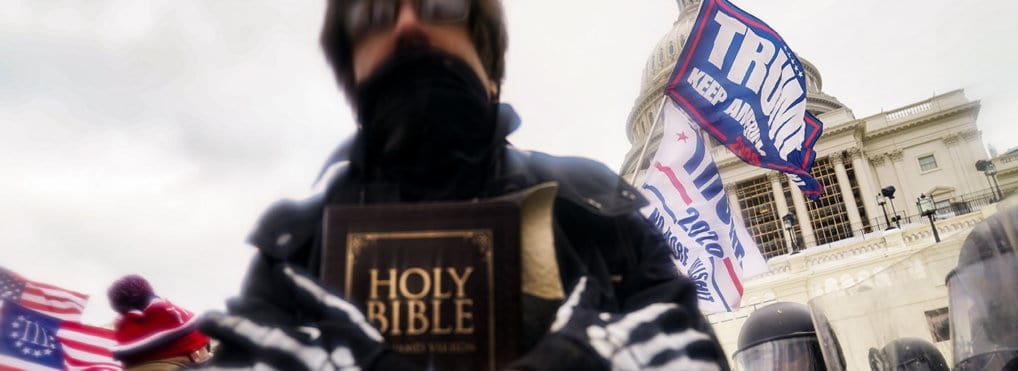 January 6th rioter holding a Bible.
