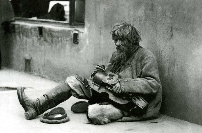 Homeless man sitting holding a Lyra. Beggar with a Lyra, Nikolay Svishchev-Paola, 1900s.