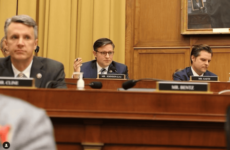 Mike Johnson is shown sitting in a chamber room.